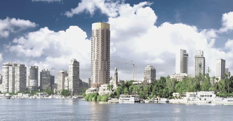 Egypt city residential tower blocks by the river with greenery