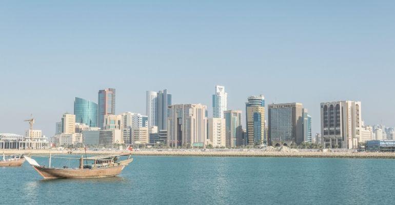 Scenic skyline of Manama with a Dhow boat in Bahrain.jpg